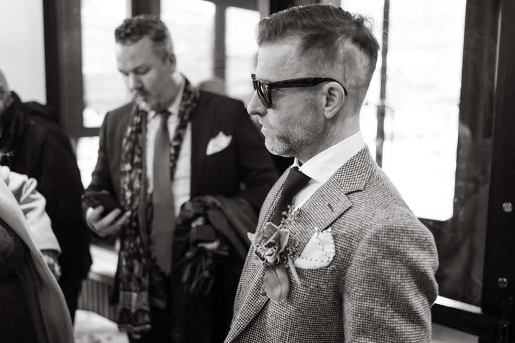 Close up candid photo of the groom wearing sunglasses before heading out to the ceremony