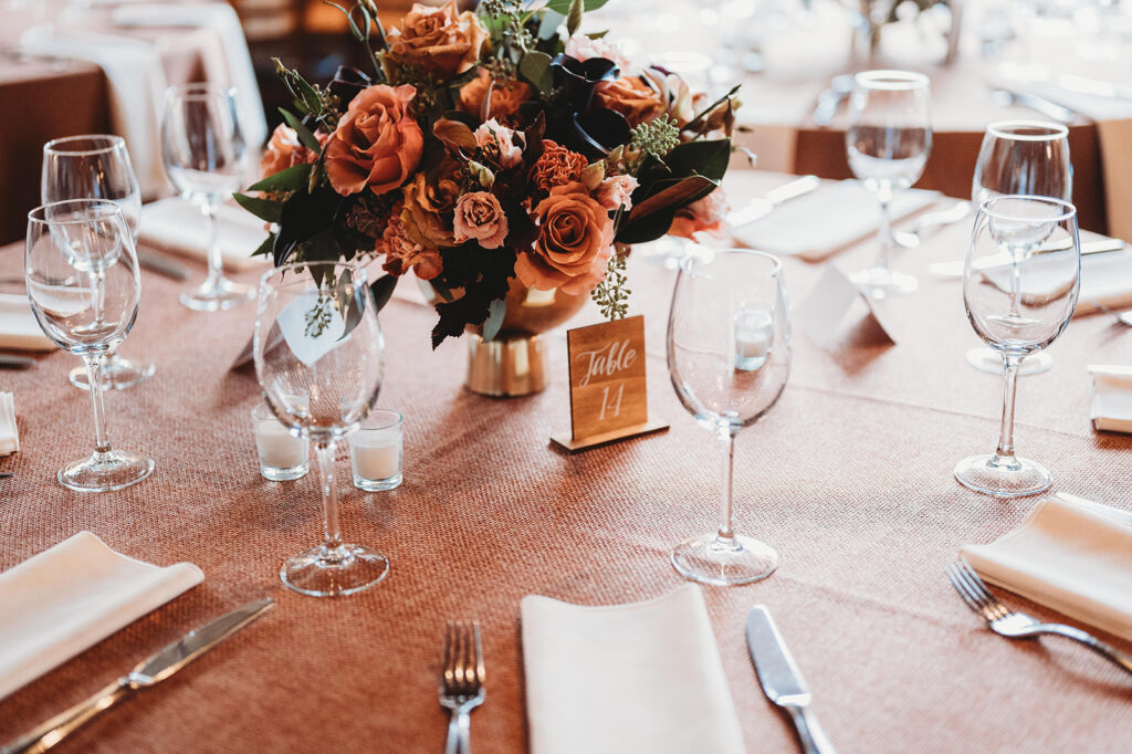 Detail photo of table setup with floral centerpiece and wineglasses.