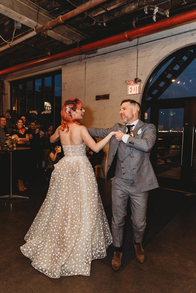 Bride and groom during their first dance during cocktail hour at Strong Rope Brewery